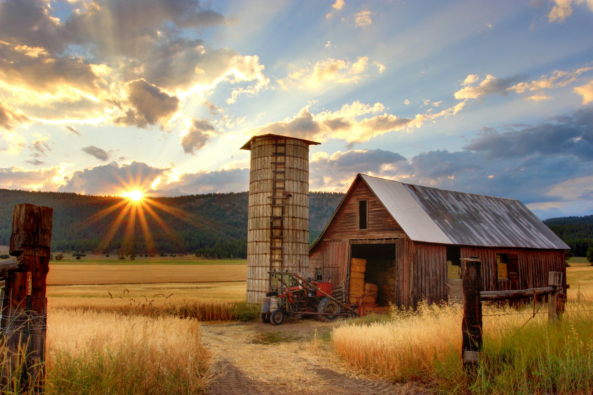 Texas-style ranch land with a barn at sunrise