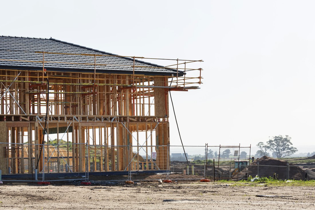 A new home under construction with a wood frame and windows